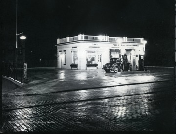 A car is getting gas at the Pure Oil Gas Station on Main Street in Grafton, West Virginia.
