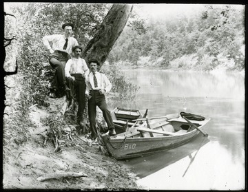 Three B&amp;O employees standing by two B&amp;O rowboats in water.  Grafton, W. Va.