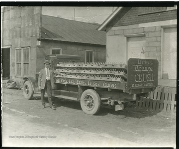 An employee is standing in front of a truck at the Halbo Beverage Co. in Grafton, West Virginia.