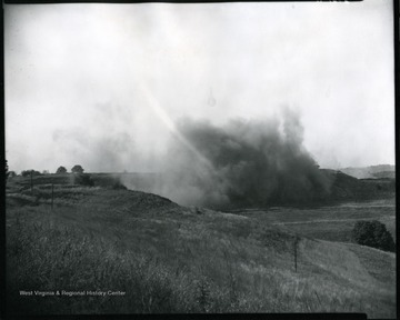Large cloud of smoke along a hillside at an unidentified strip mine site near Grafton, West Virginia.