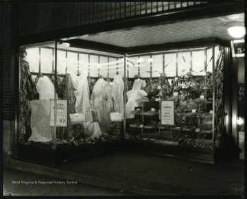 Window display featuring curtain materials and candies at the F.W. Woolworth Co. Store in Grafton, W. Va.