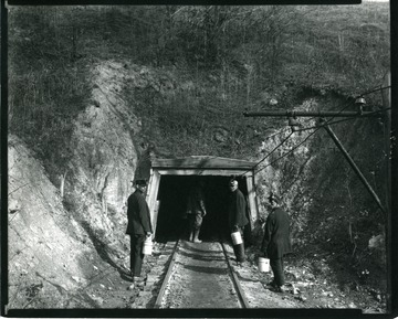 Four miners are entering a shaft at an unidentified coal mine near Grafton, West Virginia.