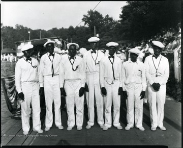 African-American men dressed up in their uniforms line up for a group portrait.