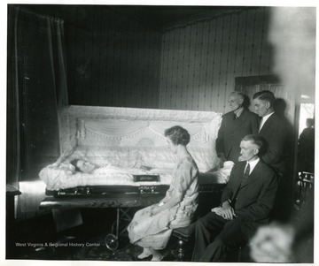 Mourners sit near Mrs. Zarko's casket in Grafton, West Virginia.