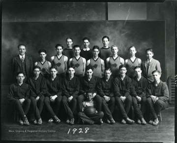 Members of a Boys Basketball team pose for a group portrait.