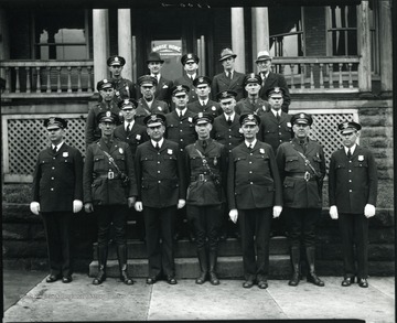 Police men line up for a group portrait outside of the Moose Home.