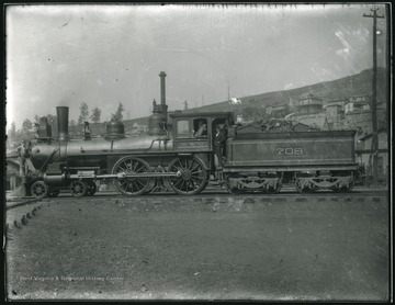 Baltimore and Ohio Train No. 708 with men in the cabin.  Another man standing on the front of the train, Grafton, W. Va.