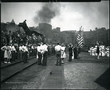 Men, women, and children gather at a ceremony at the Baltimore and Ohio railroad yard in Grafton, W. Va.