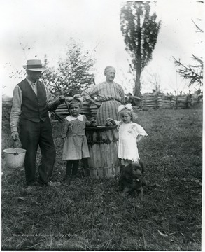 Gottfried and Marianne Aegerter with their grandchildren standing next to a barrel.