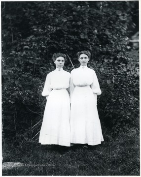 Two women standing in front of brush, Helvetia, W. Va.