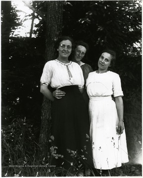 Three young women standing together under a tree, Helvetia, W. Va.