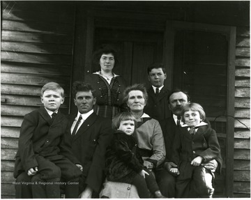 Eight people pose for a family portrait.
