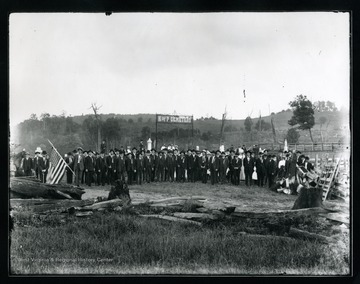 Group gathered at the Knights of Pythias Cemetery in Pickens, W. Va.  One man holds a large American flag.