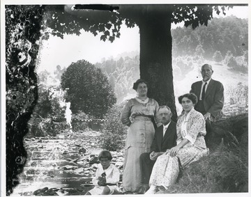 A family is sitting near a creek in Helvetia, West Virginia.