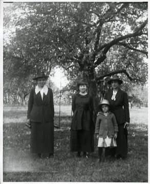 Dora Huber(left), sole African American resident in Helvetia, West Virginia, and two other woman and a child.