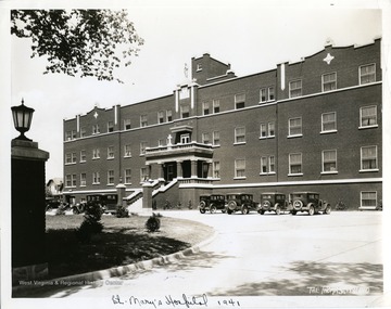 Several cars are parked in front of St. Mary's Hospital buildling in Huntington, West Virginia.