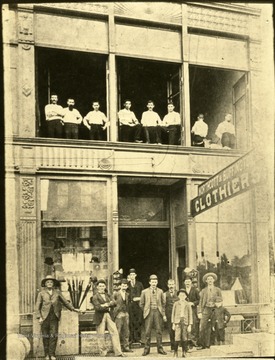 'Northcott and Buffington's Store, south side 3rd Ave. just east of 9th St.  Maybe your grand-daddy bought his clothes there.  Left to right: 1.unknown; 2. P. C. Buffington; 3. G. A. Northcott; 4. L. M. Newcomb; 5. John Shively; 6. Phil Renich, 7. Lee A. D. Tate; 8. unknown; Front Boys Left to Right: 1. W. O. Dickey.; 2. unknown.'