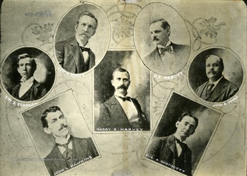 From left to right: Tim S. Scanlon, John L. Hawkins, Geo N. Biggs, Harry C. Harvey, D. E. Abbott, Gus A. Northcott, John A. Jones.'