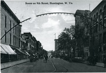 Cars and horses are in the street in Huntington, W. Va.