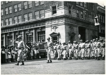 Soliders saluting the crowd during a parade, Huntington, W. Va.