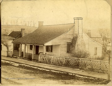 'Greenbrier's Original Courthouse, built of logs in 1778.  Was used by the Circuit and County Courts until supplanted by the Stone Courthouse in 1800.  Was then bought and transformed by William Smithers as a residence.  Was then purchased by Mr. Sallie Gilmer.  It's last owner was Mrs. Sallie Gilmer who occupied it for several years, and it finally passed into the hands of the Tuckkwiller Bros. to be torn away and the ground occupied by a handsome and commodious home for a Henry Ford Garage and Service Station.  Such is the history of the first house ever built in Lewisburg, the birthday of which is not definitely known.'