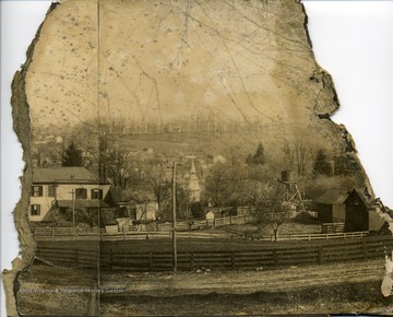 View of Lewisburg, W. Va. that includes a fenced in area and other houses.