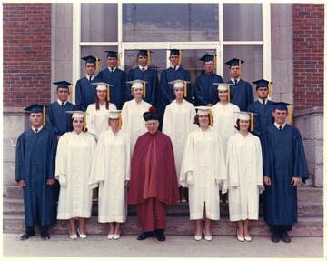 Group portrait of students in caps and gowns.  John Piccolomini is standing in the third row.