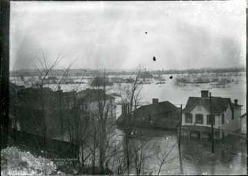Flood water raising on houses, bridge in the distant, Parkersburg, W. Va.