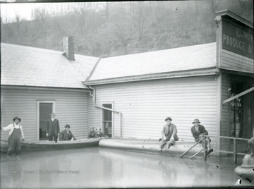 Seven men with two boats in flood waters, Parkersburg, W. Va.