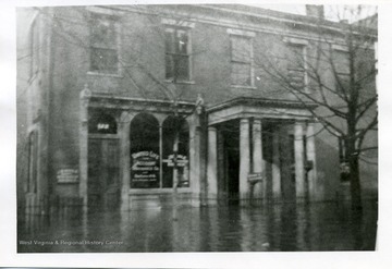 "The Van Devender Insurance Company located on 132 3rd Street between Ann and Julianna Streets. Formally Parkersburg National Bank, 1839-1904 and later the Salvation Army Building. The building was torn down in early March 1969.'