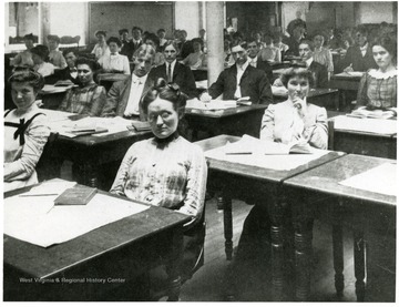 Men and women seated at desks.