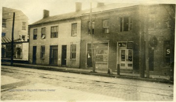 'Old Weston - Left - Bailey House - Baily House Barber Shop - bill board - Allen Simpson property now torn down 'in this building Er Ralston opened 1856' and next the Fisher property - later Weston Independent.'