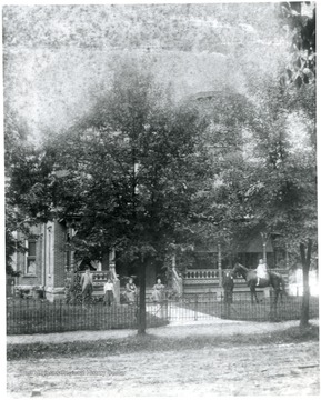 People stand outside of the home.