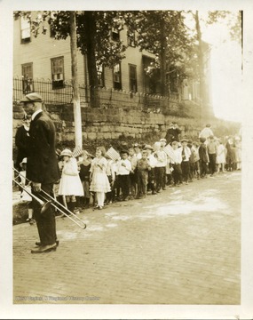 School children are participating in a parade in Thomas, West Virginia.