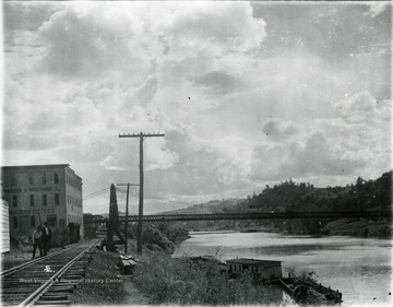 Suspension bridge known as 'The River Bridge'. View of the railroad trestle at the foot of Walnut Street. 