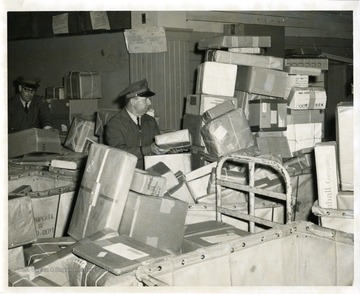 Postal workers are sorting packages at the Morgantown Post Office in Morgantown, West Virginia.