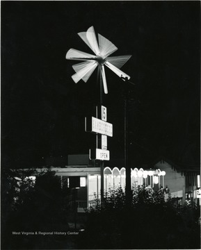 Burger Boy's Food-A-Rama restaurant where hamburgers were $.15, as it appeared at night. Sign was lit and in motion.  