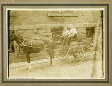 Robert L. Stewart and his son, Robert W. Stewart in their horse drawn wagon.