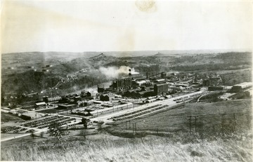 'Dupont Chemical Company, now Morgantown Ordnance Works.' A few houses surround the plant. The river is located on the far side of the plant. Automobiles can be located in the parking lots. 