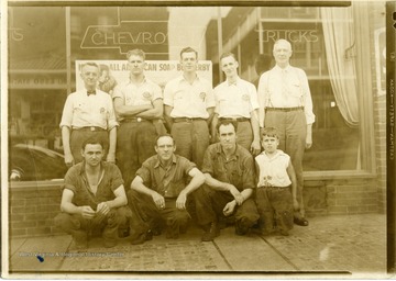 Employees of Wilson Chevrolet in Morgantown, West Virginia. Back Row: left to right: M. R. Moore, Buck Core, Lemley T. Jamison, John Lough. Front row: Earl Metseller, Okey Dewitt, Mac McGinnis, and Dave Wilson.