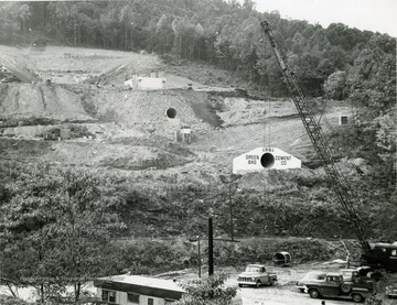 Construction site showing a crane near a culvert.