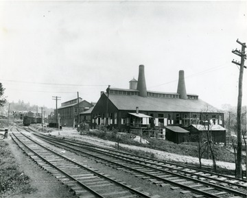 Economy Tumbler Company located next to the railway tracks in Morgantown, W. Va. Rail cars seen down the tracks. 