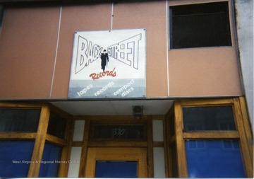 Exterior of Back Street Records located in Morgantown, W. Va. Store sign located above door of business. 