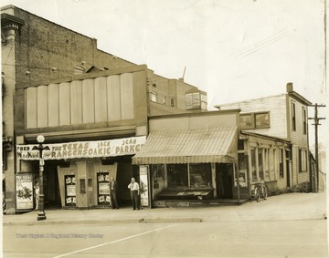 'Second arcade building on High St.  Mooney in white shirt, manager soda grill fruit market'