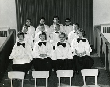 Children's Choir dressed in robes, setting in choir section. Choir at the Presbyterian Church located in Morgantown, W. Va. 