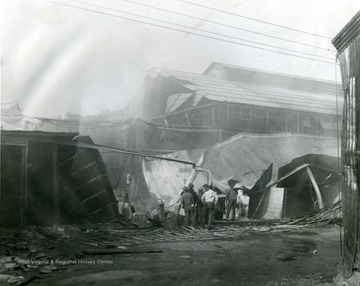 Damage of the Glass Plant fire in Star City, near Morgantown, W. Va., seen. Men look at the damage of the building.  