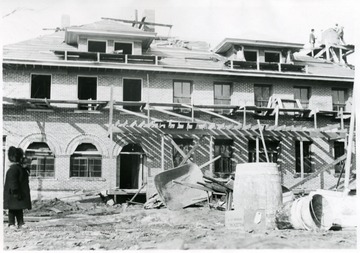 'Constructing the Geo. C. Sturgiss home, corner of Kirk and High Streets, was located behind the present Post Office building.  Photo was taken by Mrs. Geo. C. Sturgiss.  Child in photo is probably Roberta Sturgiss.'
