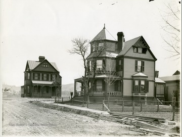'The home of the late Prof. W. P. Willey on the south-west corner of Pleasant and Spruce Streets.  Prof. Willey for a number of years was the editor of the W. Va. Bar.  Many of his articles were written in this home.  The small residence to the left is the home of Miss Hattie Tennant.  These homes were built about 1885.'