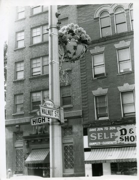 Flower decoration is hanging on the Walnut and High Street's signpost in Morgantown, West Virginia.