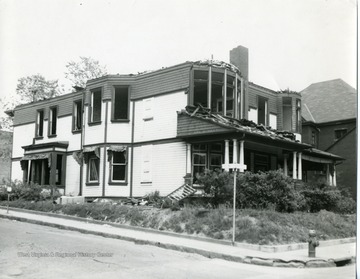 'Old house north east corner of Fayette and Chestnut Streets being razed for city parking lot in Morgantown, West Virginia.'